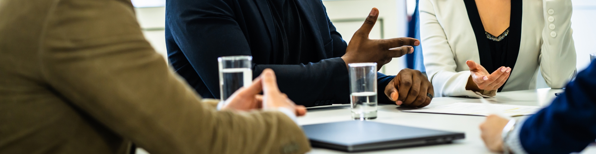 Close-up of hands of people meeting around a table